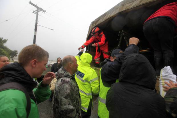 Evacuees are loaded into a Unimog after rescue from the Brooklyn area, Riwaka. Photo / Tim Cuff