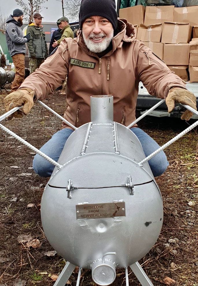 Kiwi K.A.R.E founder and chairman Tenby Powell with one of the 3000-plus donated water boilers and heaters for Ukrainian families. Photo / Supplied 