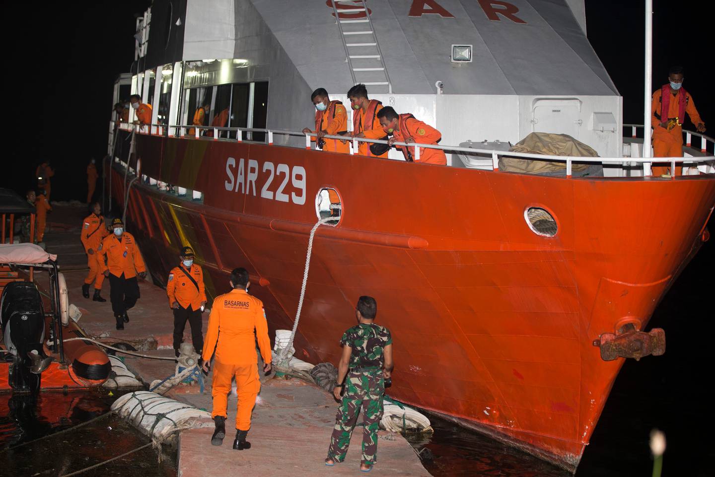 Members of National Search and Rescue Agency prepare for the search mission. Photo / AP