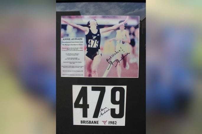 Anne Audain's framed bib and photo from winning gold at the 1982 Brisbane Commonwealth Games. Photo: Debbie Griffiths