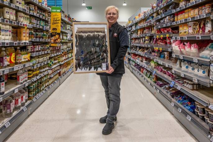 New World's Sally Valois with the framed korowai. Photo / David Hall