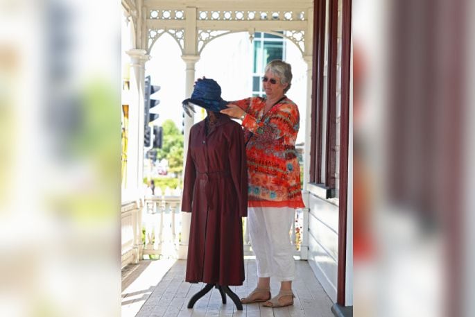 Tauranga Historical Society president Julie Green with a garment worn by one of the sisters.  Photo: John Borren.