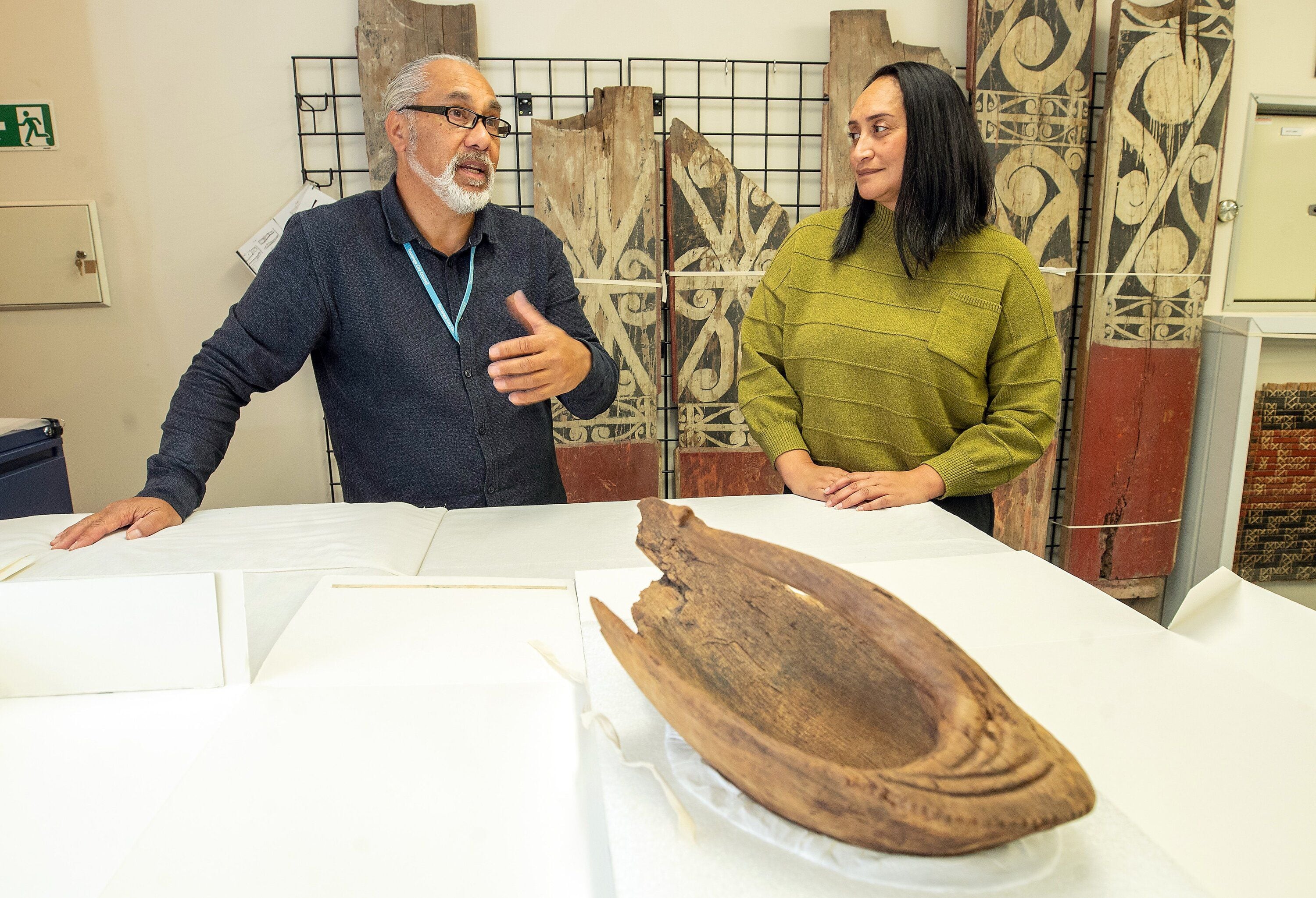 Te Pou Arahi cultural heritage manager Dean Flavell and museum collection specialist Chelsea Tairi with a 14th-century wooden canoe bailer. Photo / John Borren