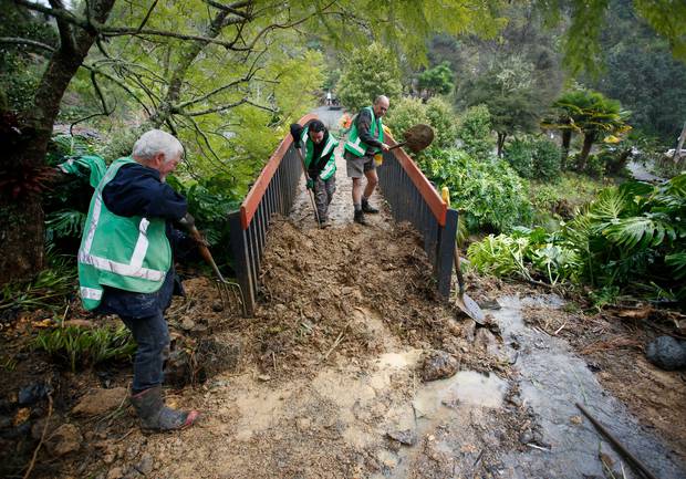 Volunteers (from left) Mike Morresey, Kayla Franks and Stuart Peterson get stuck in. Photo / Michael Cunningham