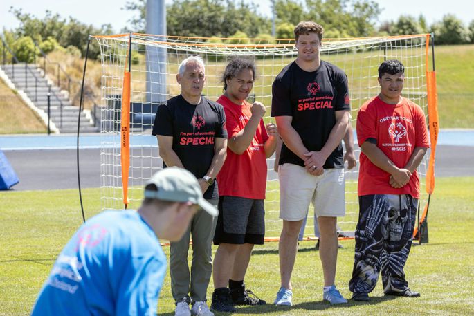 Games ambassadors Scott Barrett and Jason Gunn line up in a wall with Special Olympics athletes during a friendly football match at Ngā Puna Wai last month.