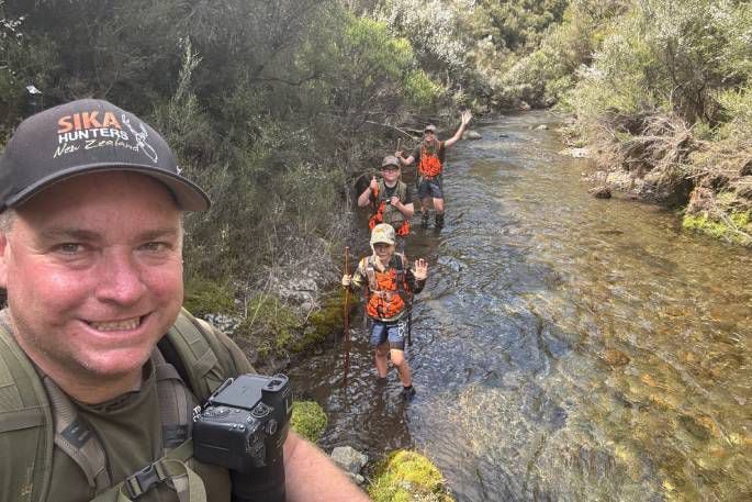 (From left): Jamie, Fletcher, James and Amie Fairbairn crossing a stream in the Kaimanawa Range.