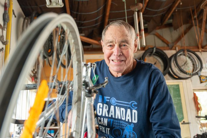 Lex Spencer fixing a bike in his Maungatapu shed. Photo/ Brydie Thompson.