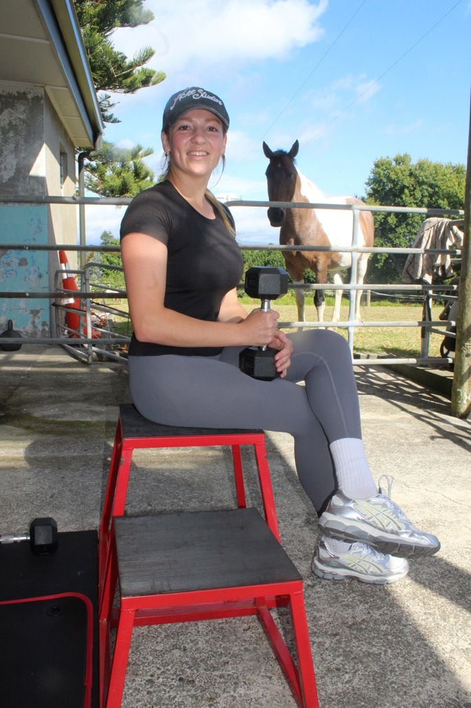 Anneli Deschamps with Penny the clydesdale/paint horse peeking inside the Cow Shed Gym. Photo: Rebecca Mauger