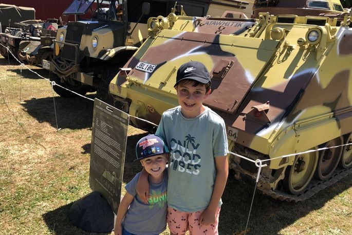 Checking out the military vehicle display is Theo Mortensen, 5, and Blake Flanagan, 9, from Welcome Bay. Photo: Rebecca Mauger