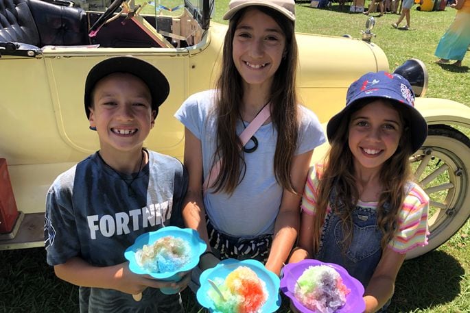 Orion, Naomi and Aviana from Tauranga enjoy some crushed ice. Photo: Rebecca Mauger