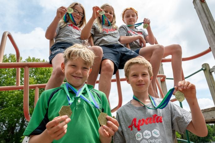 Pahoia students Harvey Oemcke and George Bent, with Aria Pryce, Indie Woolsey and Indy Ward at back, want other BOP kids to enter their school’s Have A Go TRY-athlon. Photo: David Hall