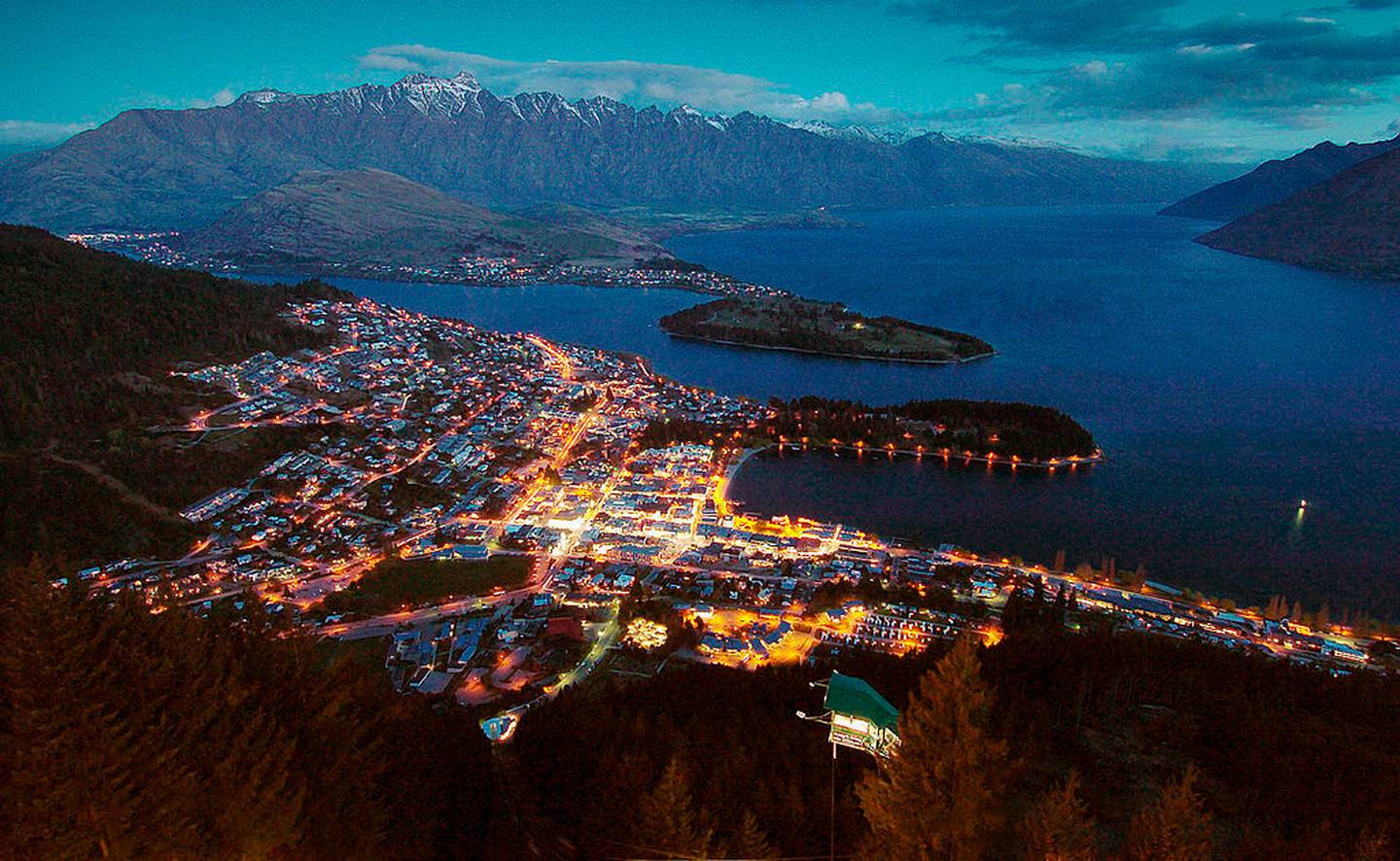 Queenstown at dusk with Lake Wakatipu and the Remarkables mountain range. Photo / Getty