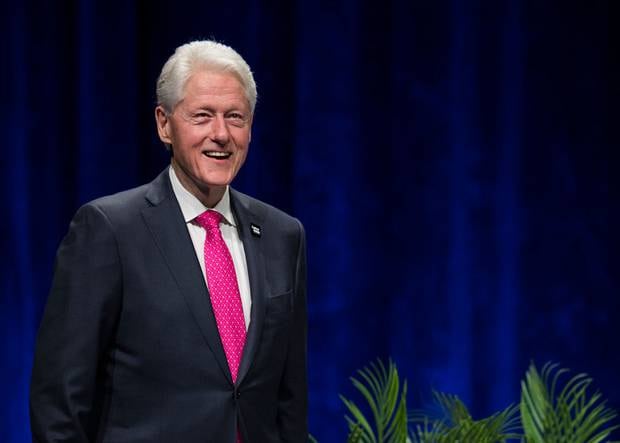 Newly unearthed photos showed her giving President Bill Clinton receiving a massaged from one of Jeffery Epstein's alleged victims. Photo / Getty Images