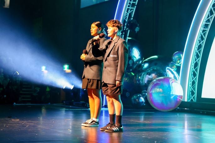 Two students lead the audience in singing the NZ National Anthem at the 2024 Zespri AIMS Games Opening Ceremony on Sunday September 8, 2024. 