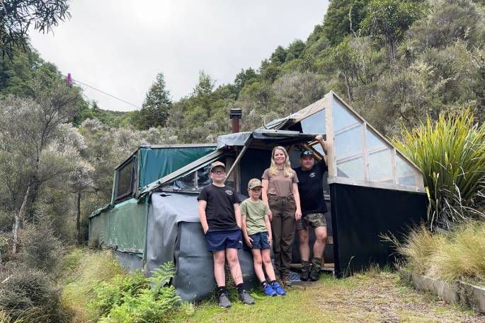 (From left): James, Fletcher, Amie and Jamie Fairbairn outside the hut built by Jamie's uncle in 1993.