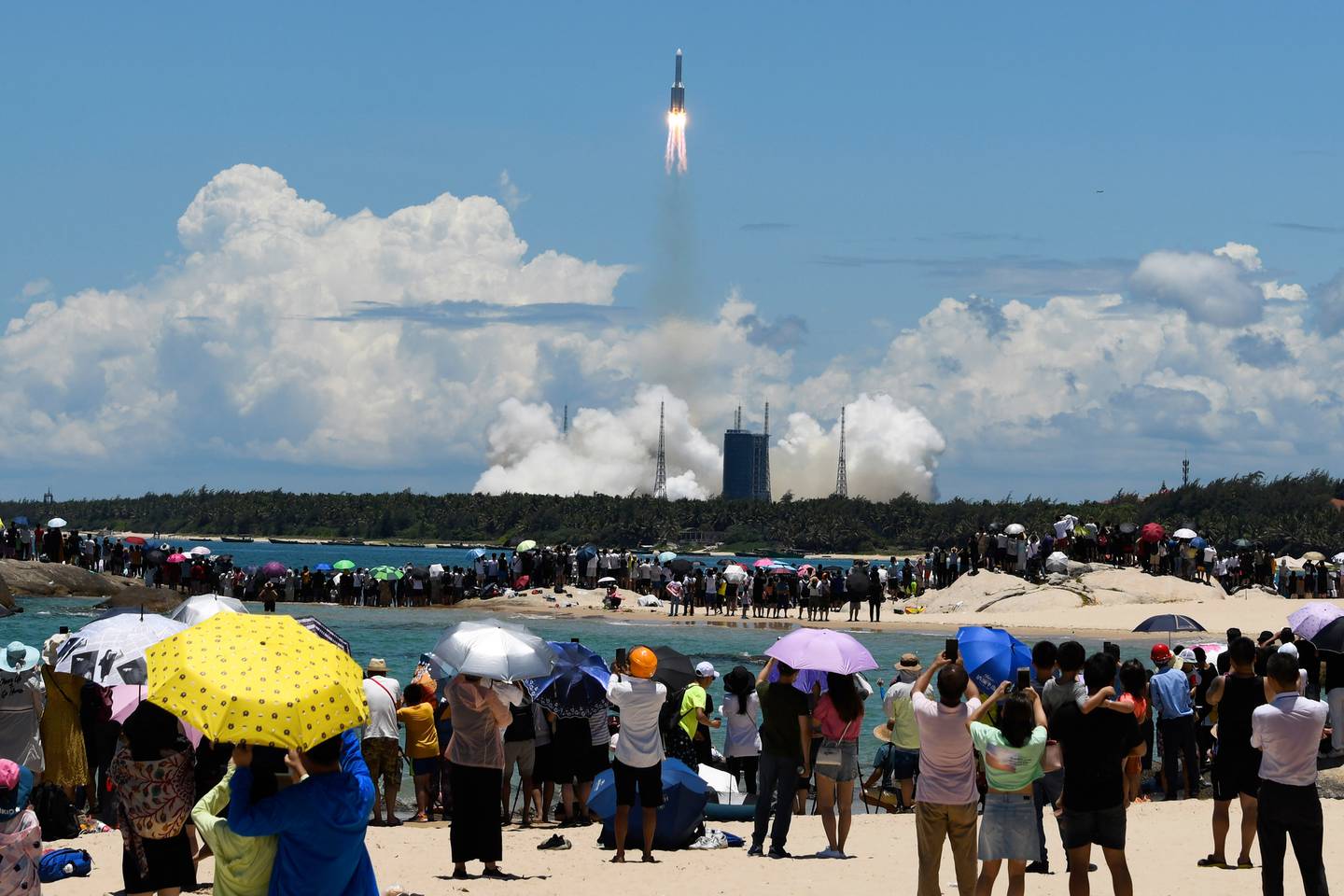 Spectators watch as a Long March-5 rocket carrying the Tianwen-1 Mars probe lifts off from the Wenchang Space Launch Center in southern China's Hainan Province. Photo /AP