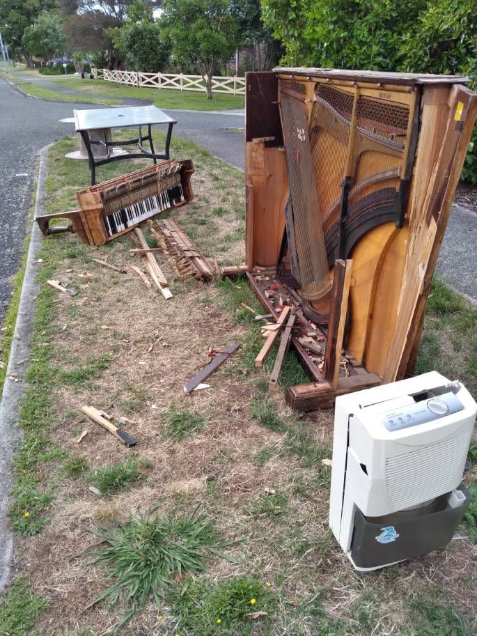 An illegally dumped piano and other rubbish found by Tauranga City Council. Photo / Tauranga City Council