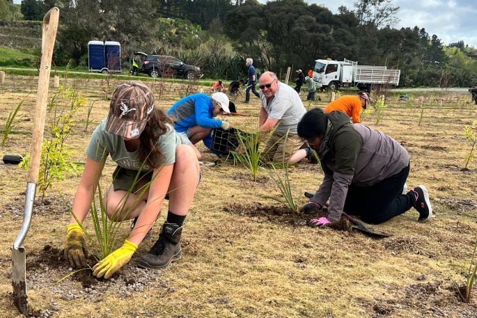 Sylvie Brown from ACG, Geoff Brown (at back), and Karpaga Kanniya Muthu helping plant 4500 plants in Kōpūrererua Valley on September 29. Photo: Supplied.