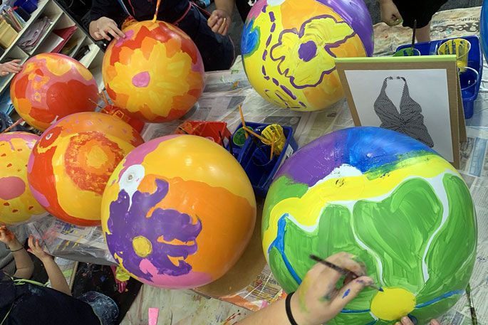 Children from Pillans Point School painting beach balls for the Sara Hughes Reimagine Tauranga exhibition.