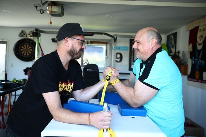 Neighbour Dylan Carter gives Anton van der Westhuizen a fun challenge in his Pāpāmoa garage. Photo: John Borren