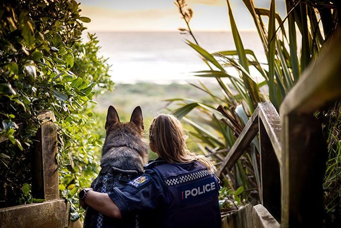 One of her favourites is of Constable Sarah Stichbury and patrol dog Ari at the beach, above. The photo, taken from behind with the sun going down, features as the main image for September.