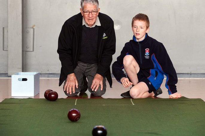 Tauranga Special School student Regan Unsworth-Taylor and team coach Kevin Garratt are all concentration during a practice for the indoor bowls competition that will be part of 2024’s Zespri AIMS Games. Tauranga Special School is entering the huge school sporting event for the first time. Photo: Alan Gibson.