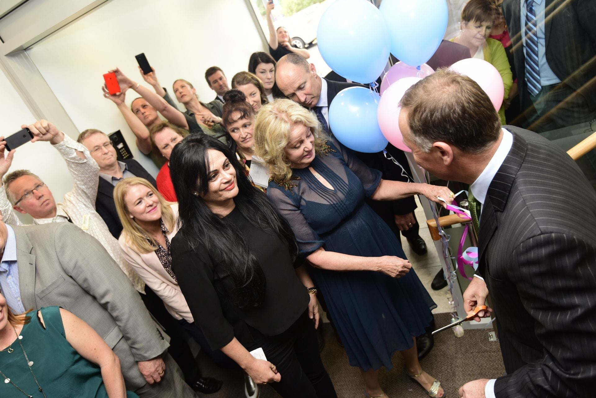 Bethlehem Birthing Centre co-founders Nicky Campbell (left) and Chloe Wright at the official opening with former Prime Minister John Key cutting the ribbon. Photo / George Novak