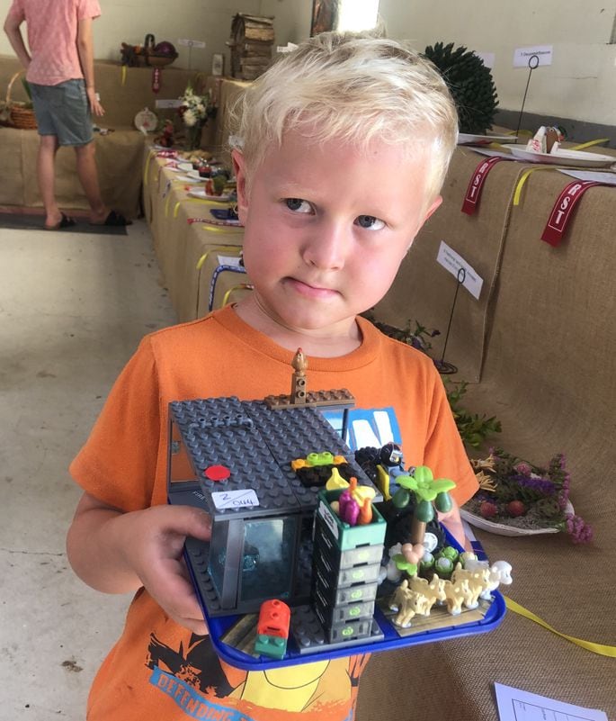 Ted Griffin, 4, with his winning Lego farm themed creation at the Home Industries area. Photo: Rebecca Mauger