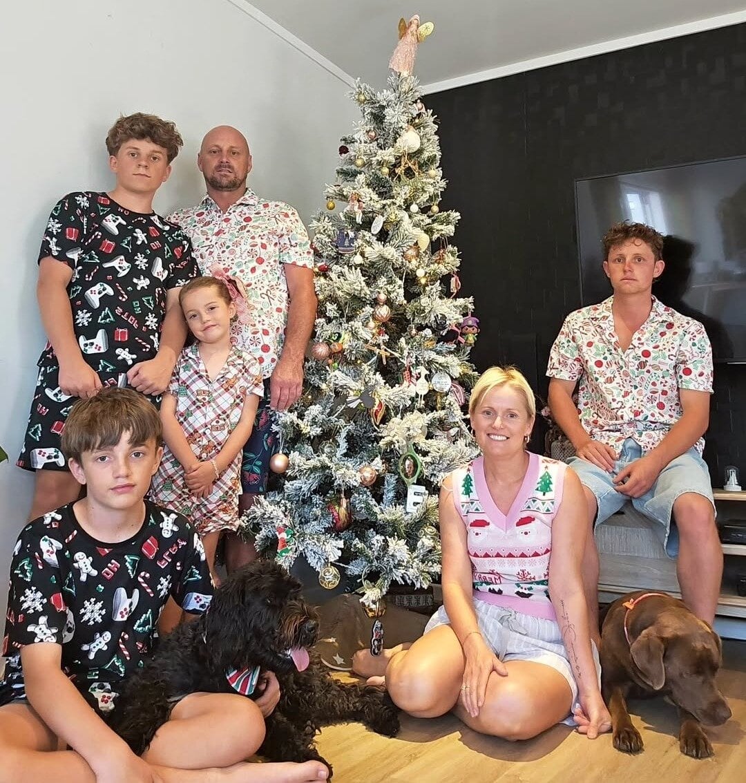 The Crane family Christmas photo: Travis, 15, husband Steve, daughter Esmae, 7, Hayden,12, Kristian, 20, Sarena, and dogs Pinot and Maggie. Photo / Supplied