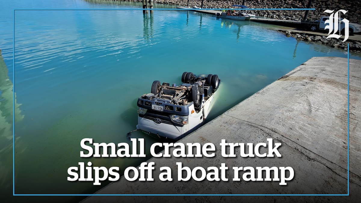 Small crane truck slips off a boat ramp - NZ Herald