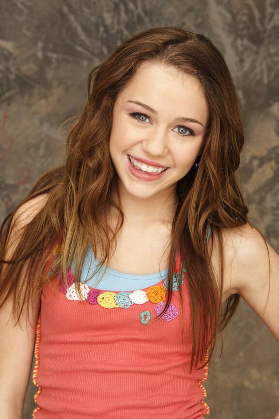 Successful beauty. Happy young brown hair woman in tank top and