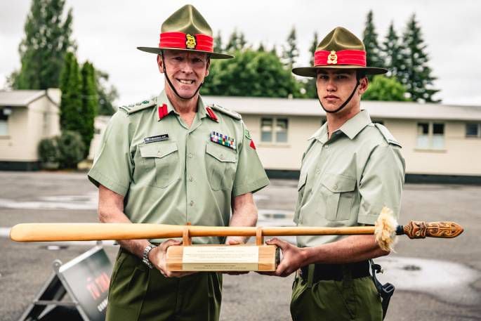 Colonel Brendon Jull, Assistant Chief of Army (Reserves), presents Private Schweizer the Top Recruit award. Photo / supplied